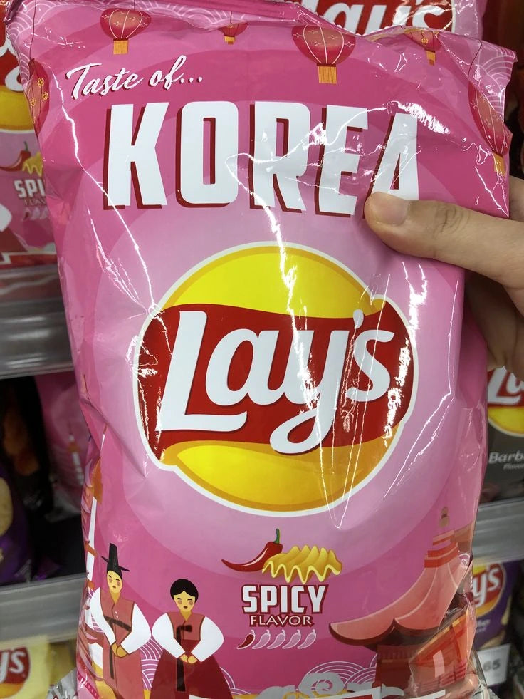 Pink Lay's Spicy Flavor potato chip bag with 'Taste of Korea' text.
